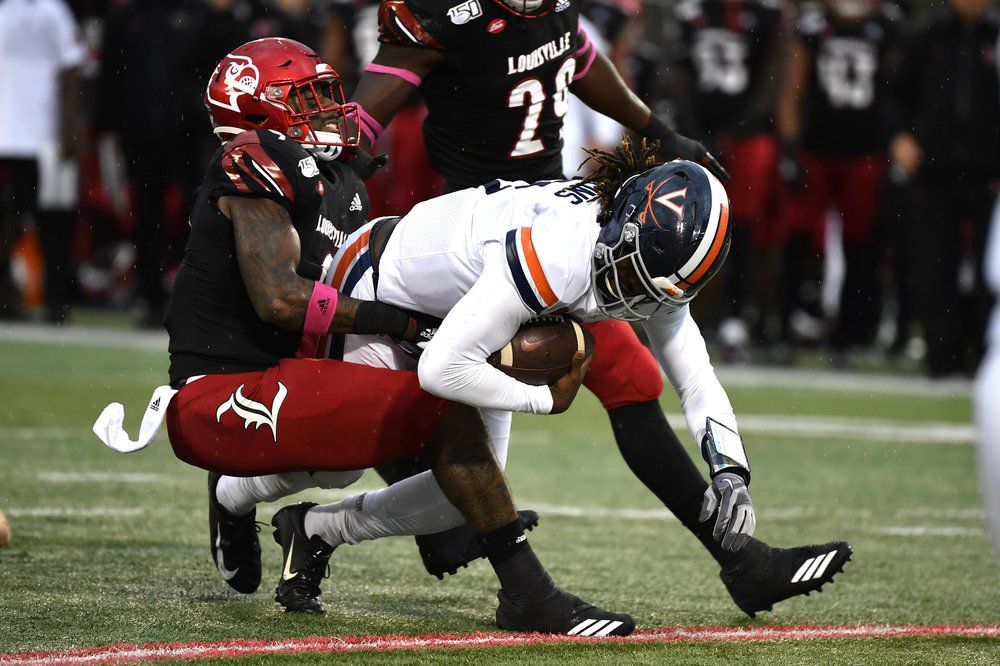 Virginia quarterback Bryce Perkins (3) is brought down by Louisville linebacker C.J. Avery